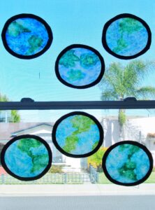 Earth Day craft hanging in classroom windows